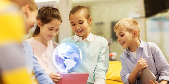 Teaching Children are watching a hologram in a classroom setting.